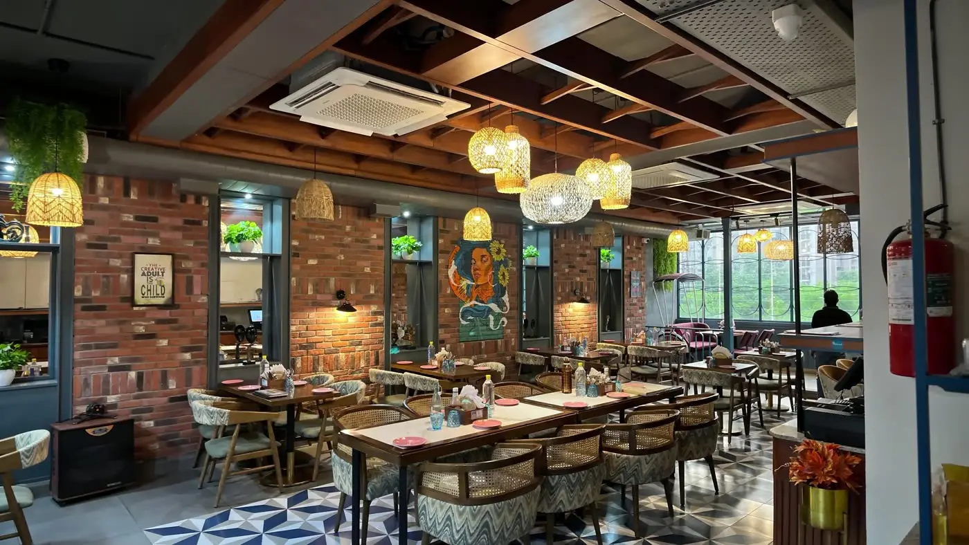 Cafe Pamaa interior with brick walls and hanging lamps