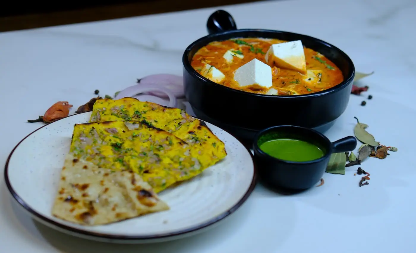 Paneer curry with stuffed paratha and green chutney